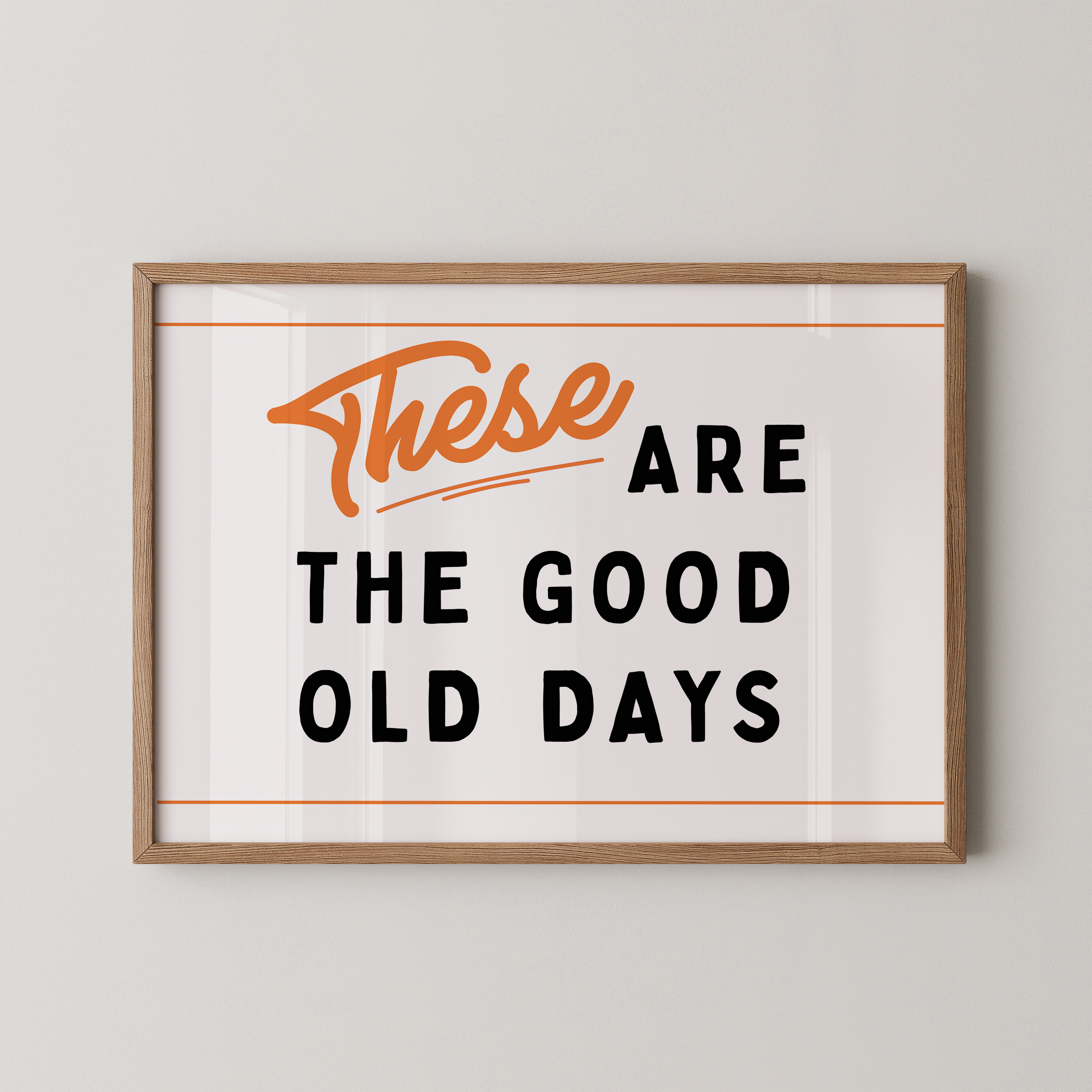 a framed poster with the text "These are the good old days" in a bold, orange font.