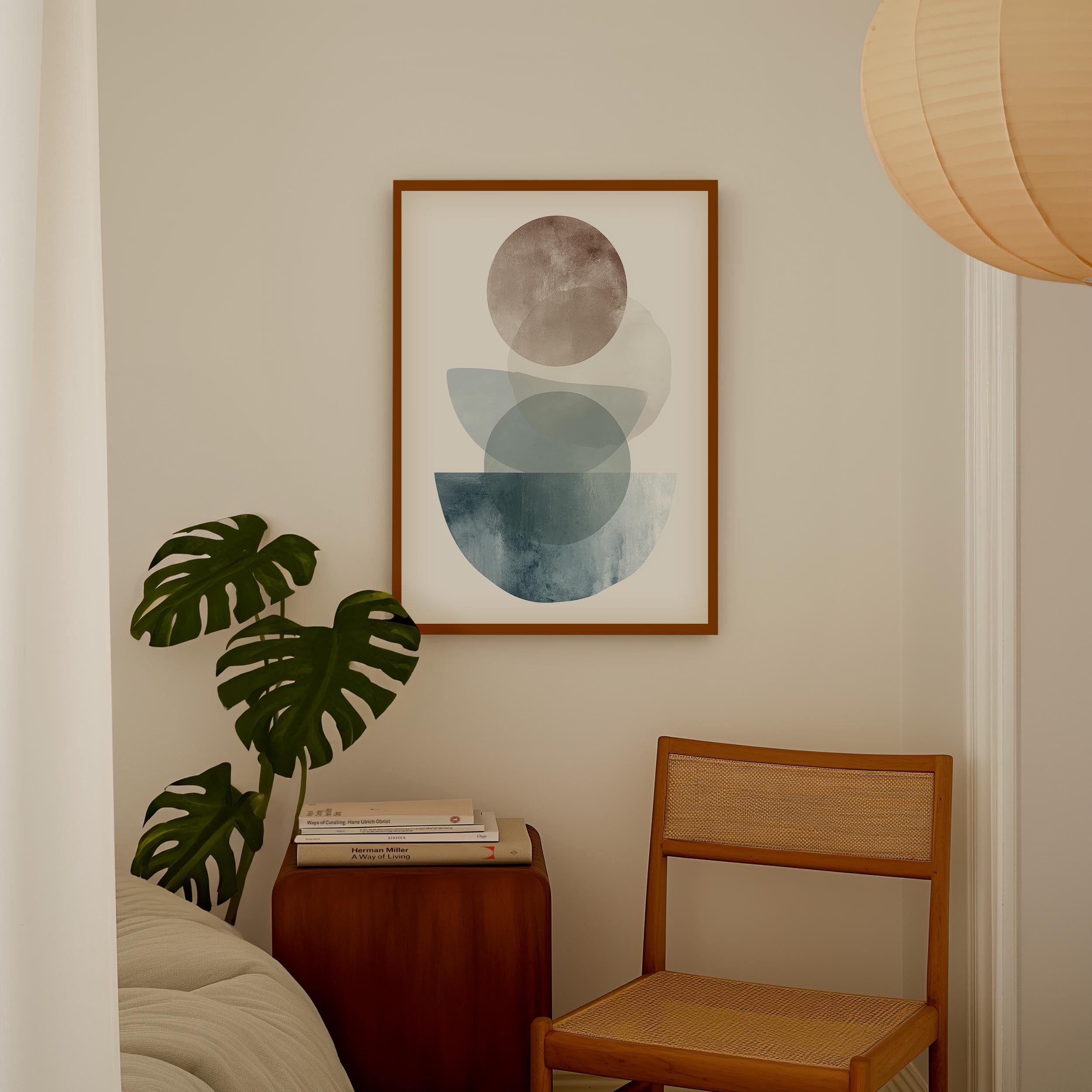 a cozy corner of a room with a framed abstract art piece hanging on the wall, a wooden chair, a small table with books, and a large monstera plant.