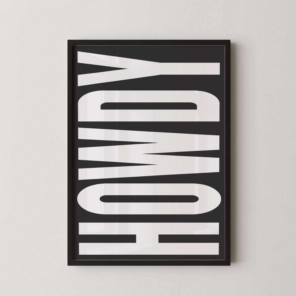 a framed poster with the word "HOWDY" written in large, bold letters.