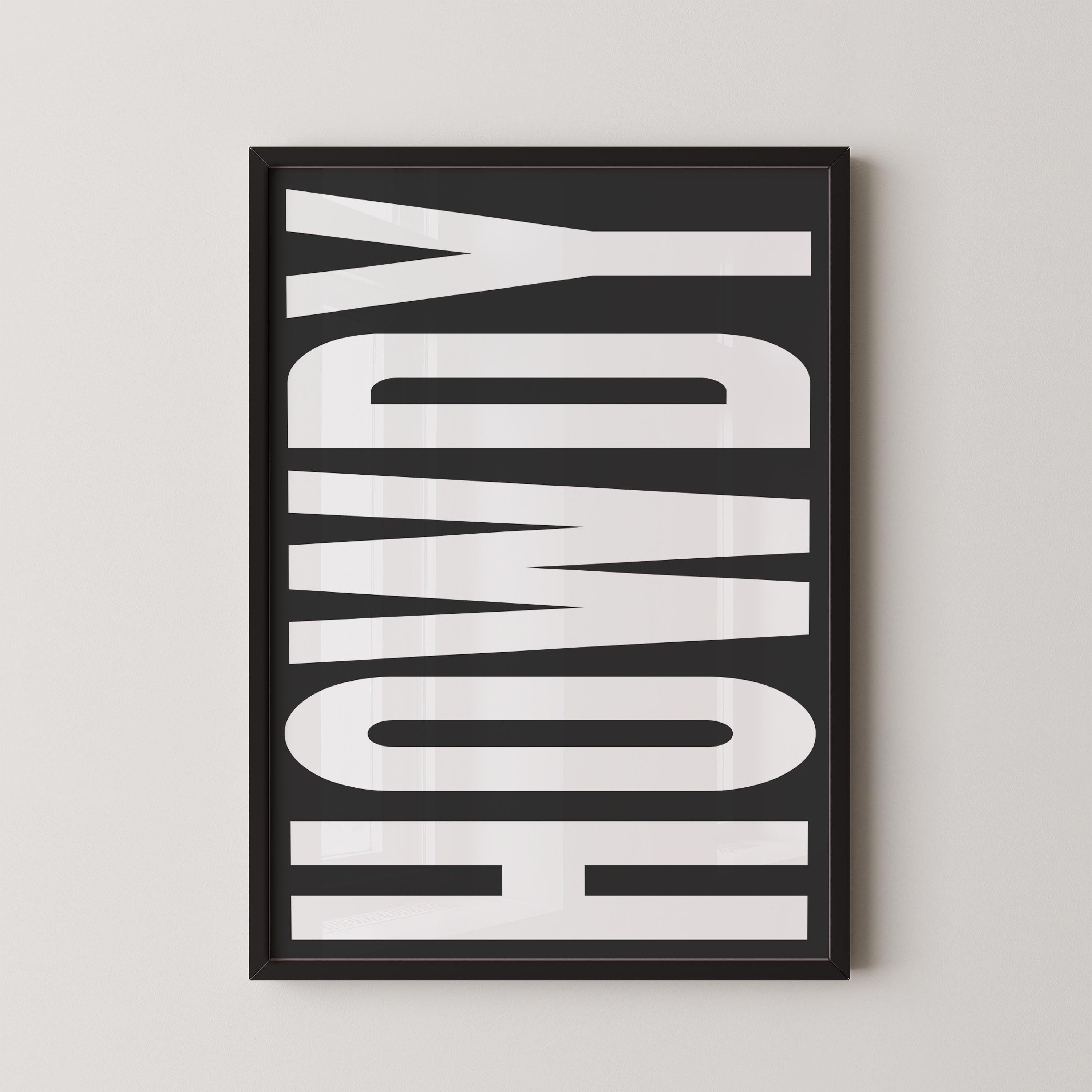 a framed poster with the word "HOWDY" written in large, bold letters.