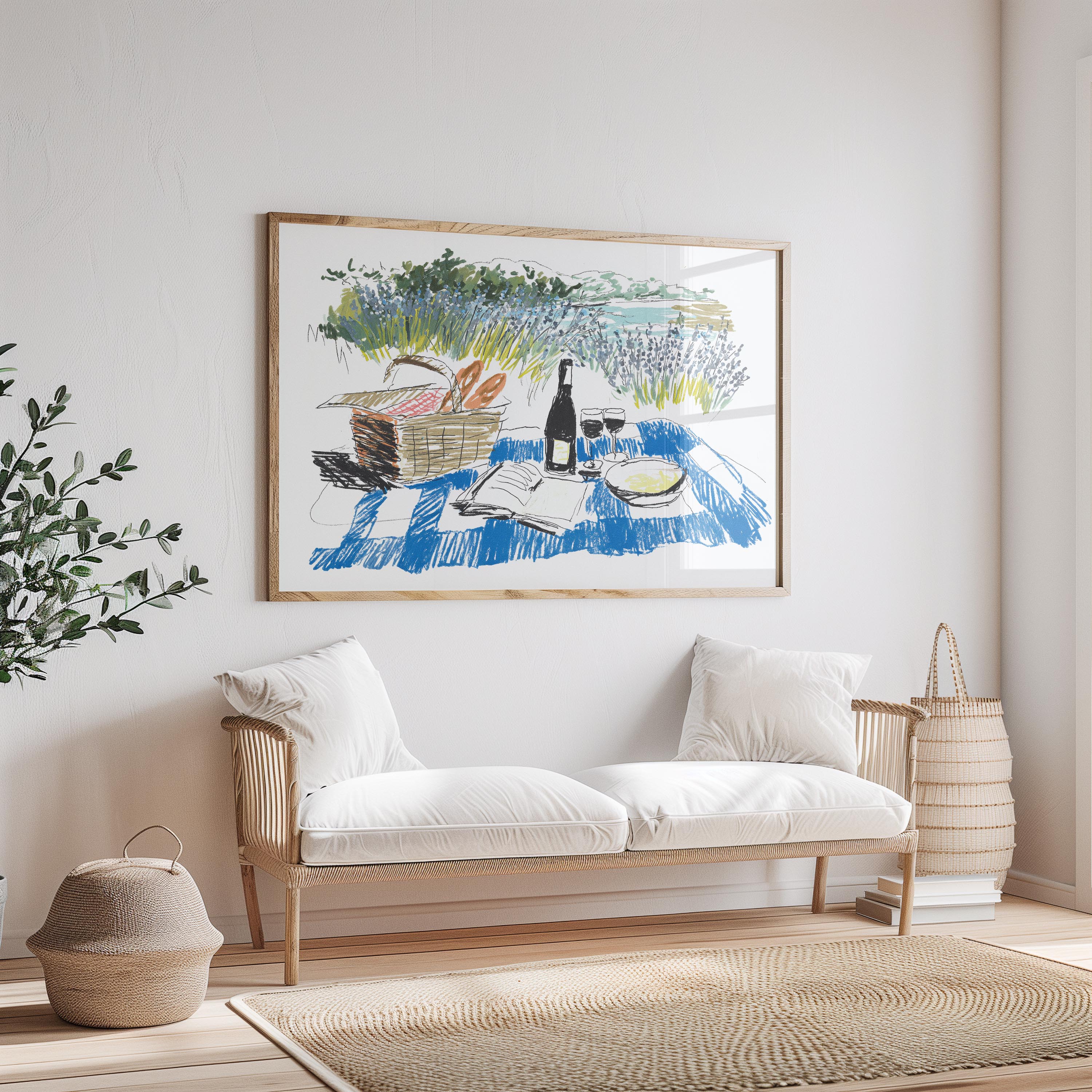 a cozy living room with a large painting of a picnic scene hanging on the wall above a white sofa. The painting depicts a picnic with a basket of food, a bottle of wine, and a book, creating a serene and inviting atmosphere.