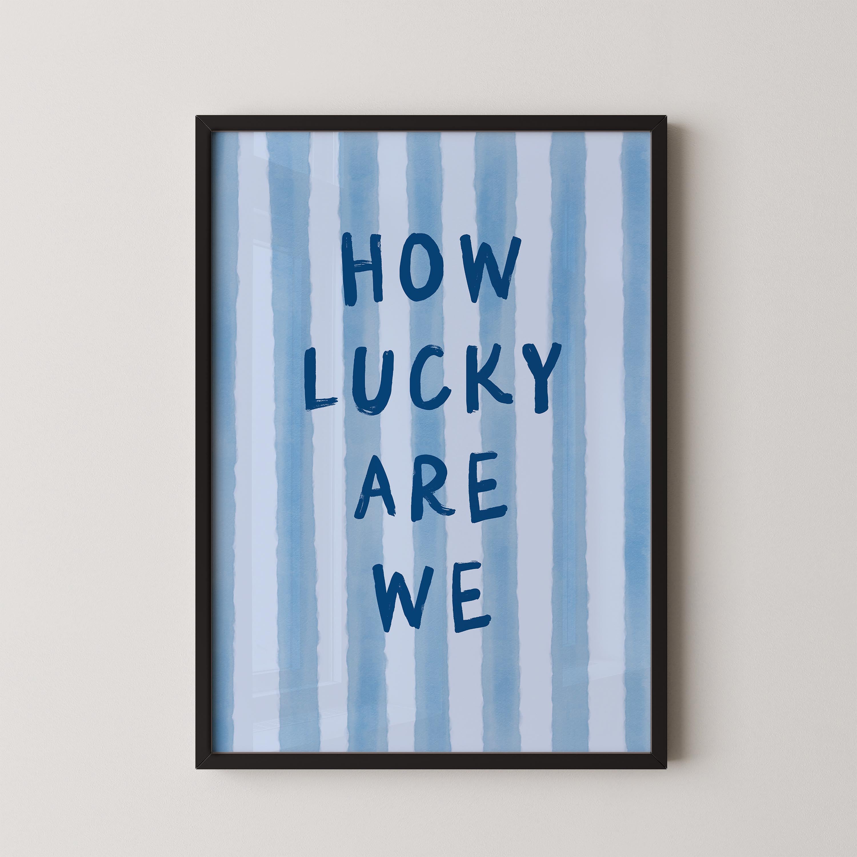 a framed poster with the text "HOW LUCKY ARE WE" written on it.