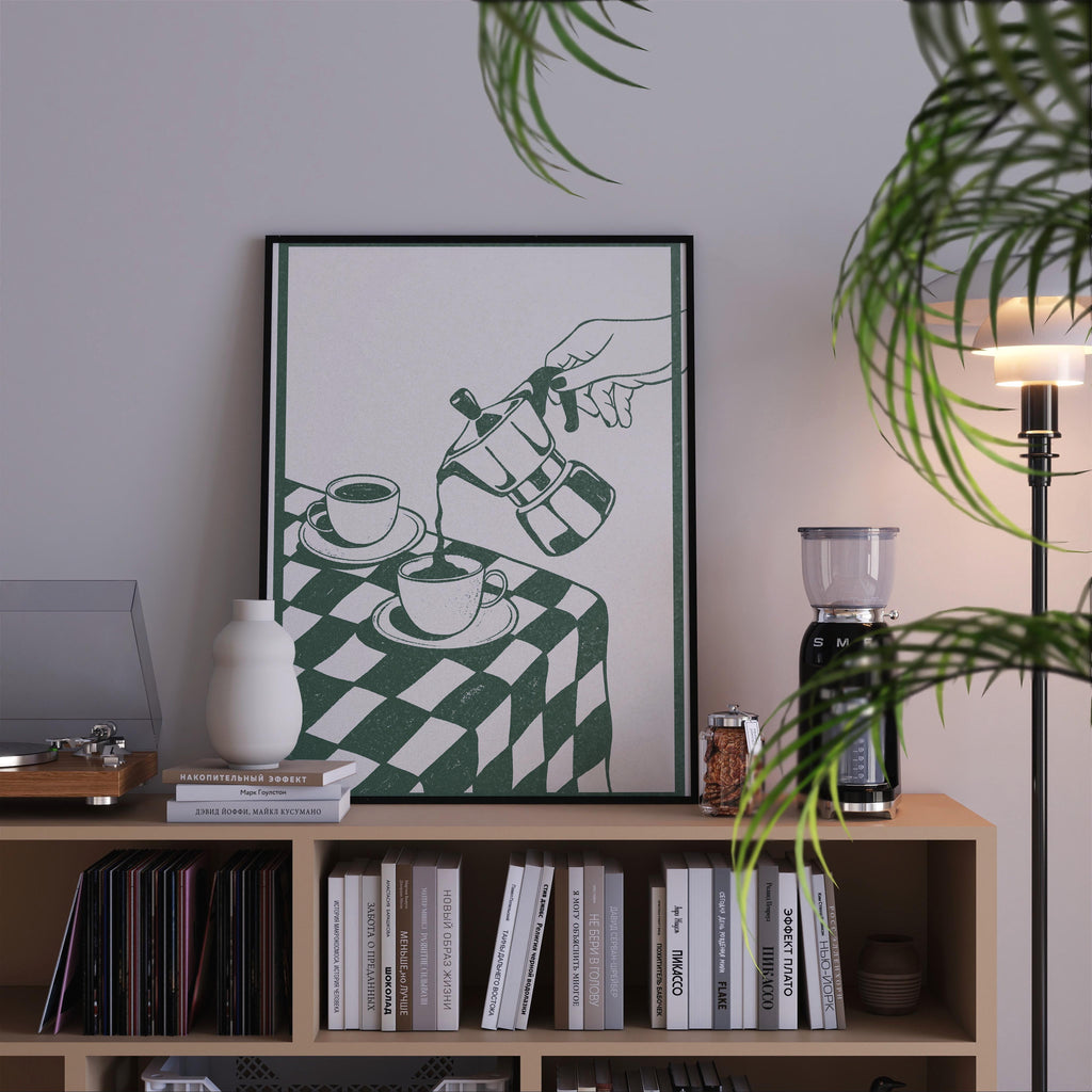 a bookshelf with a framed poster of a hand pouring coffee on a table, surrounded by various books and decorative items.