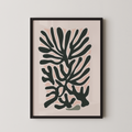 a framed abstract art print with a stylized plant-like design in black and pink colors.