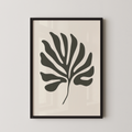 a framed black and white leaf with a unique, abstract design.
