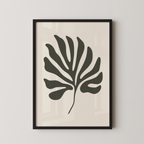 a framed black and white leaf with a unique, abstract design.