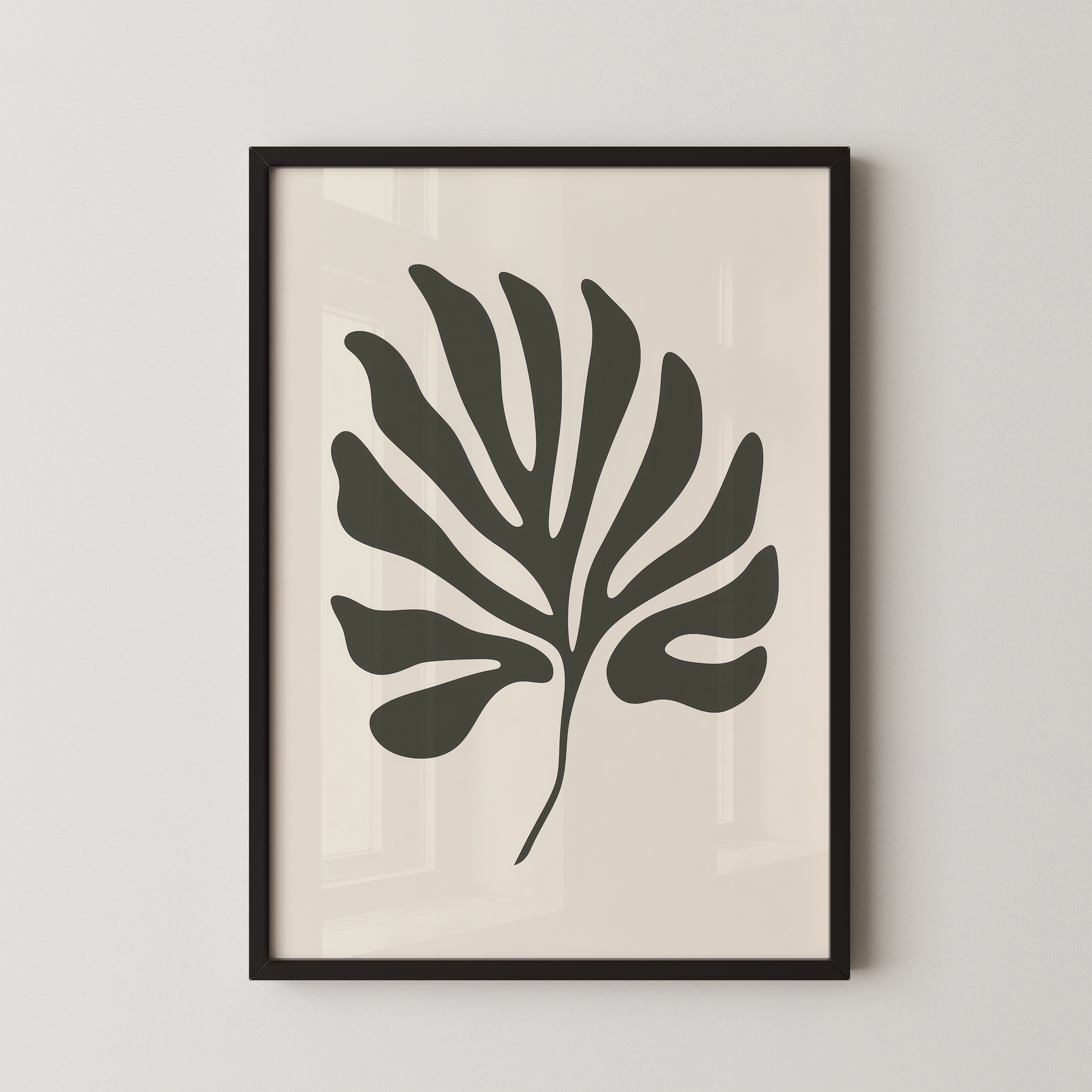a framed black and white leaf with a unique, abstract design.