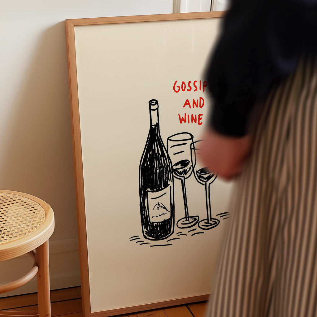 a person standing next to a framed drawing of wine glasses and a bottle of wine.