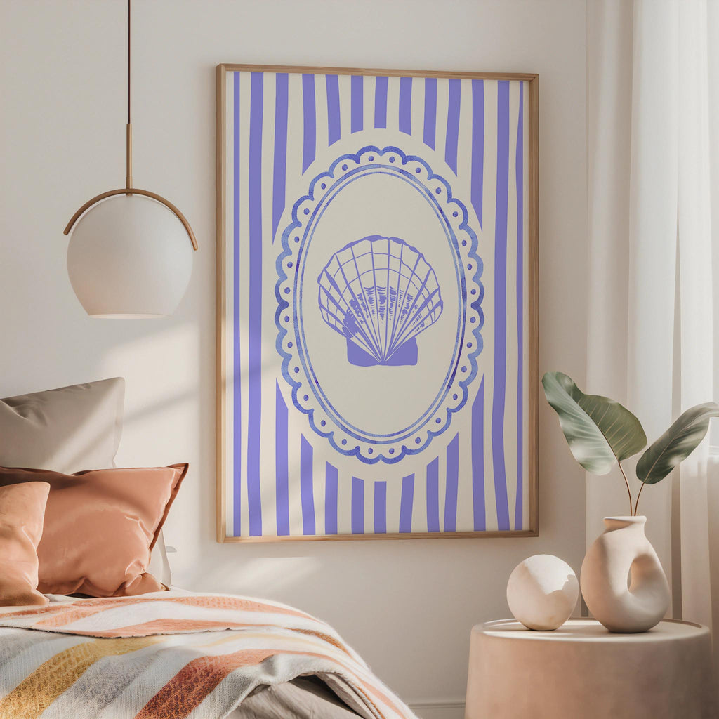 a bedroom with a bed, a framed picture of a shell on the wall, and a pendant light hanging above the bed.
