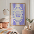 a bedroom with a bed, a framed picture of a shell on the wall, and a pendant light hanging above the bed.
