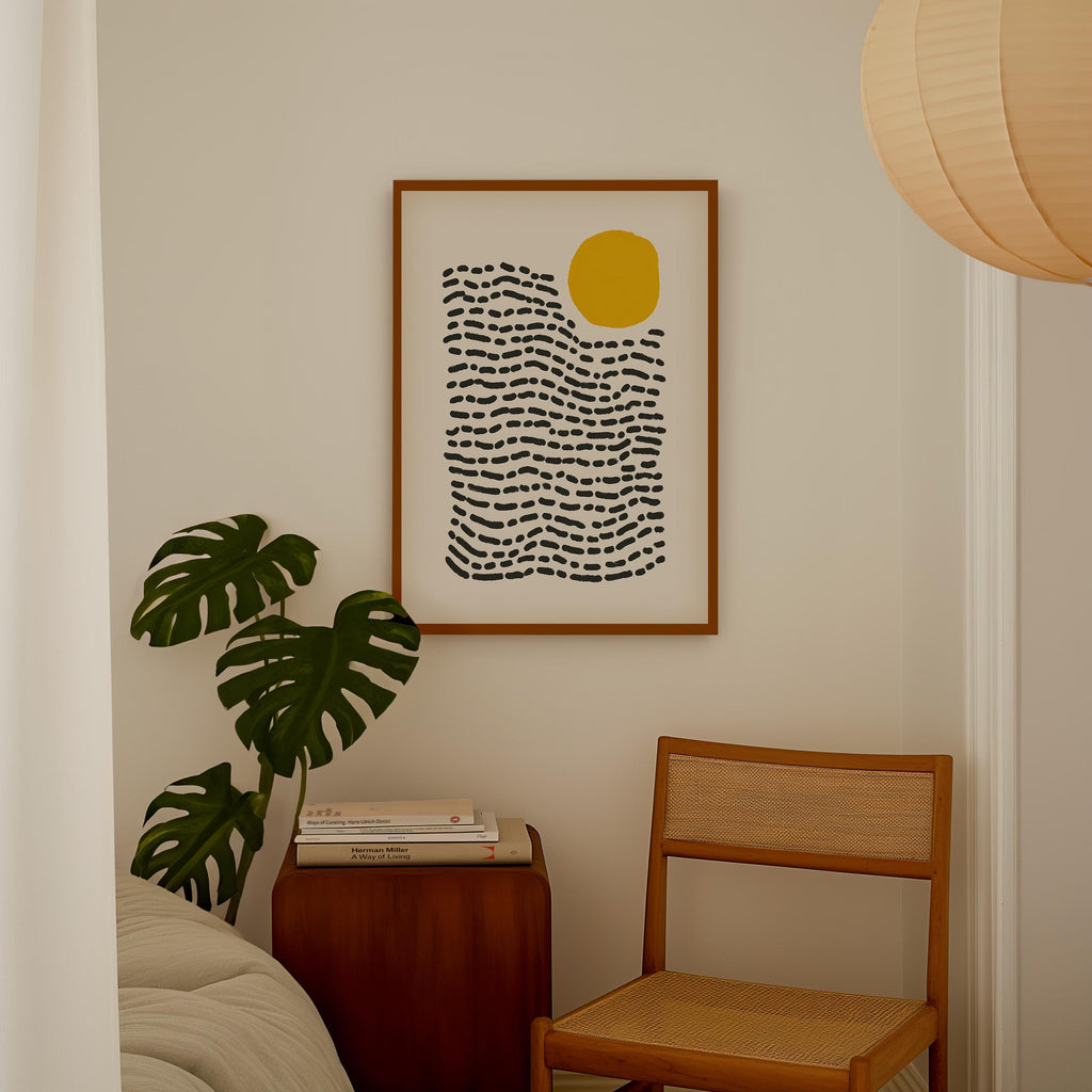 a cozy corner with a framed abstract art piece hanging on the wall, a wooden chair, and a potted plant.