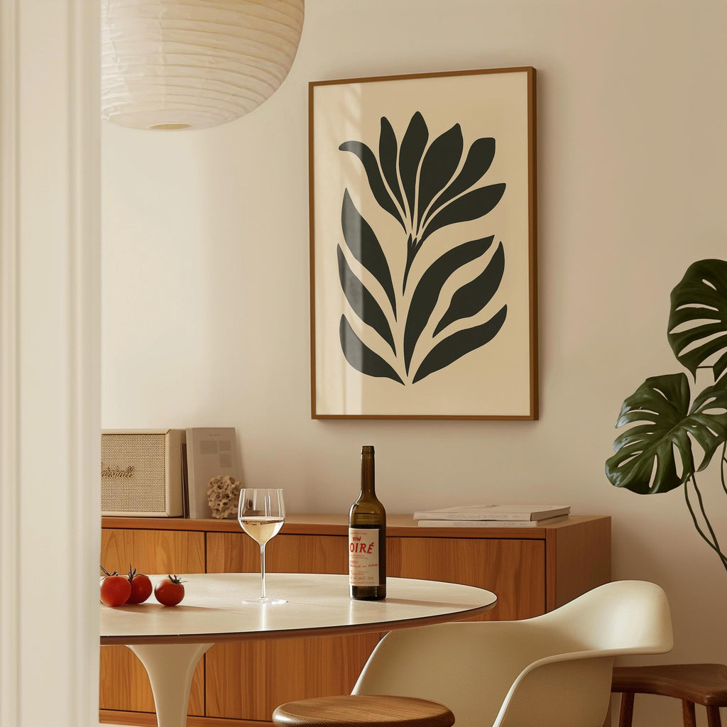 a dining area with a table, a bottle of wine, and a framed abstract floral artwork on the wall.