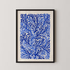 The image is a framed print featuring a repeating pattern of blue and white leaf-like shapes, creating a visually striking and intricate design.