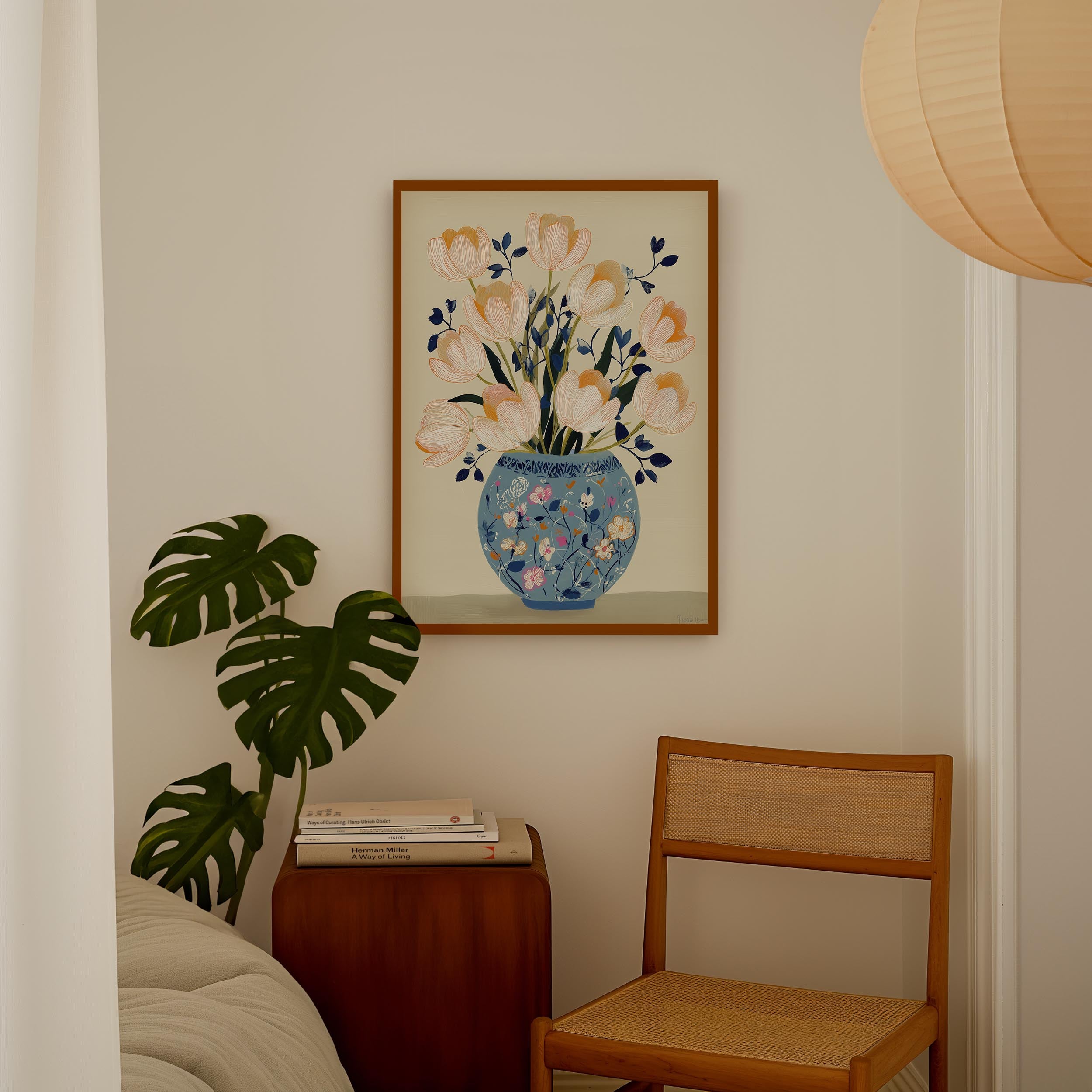 a cozy corner of a room with a wooden chair, a wooden side table, and a framed painting of a vase with flowers hanging on the wall.
