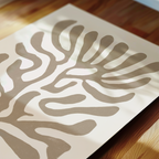 a close-up view of a piece of paper with a striking abstract design resembling a stylized leaf or plant.