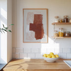 a kitchen counter with a bowl of lemons, a framed abstract painting on the wall, and shelves displaying various jars and containers.