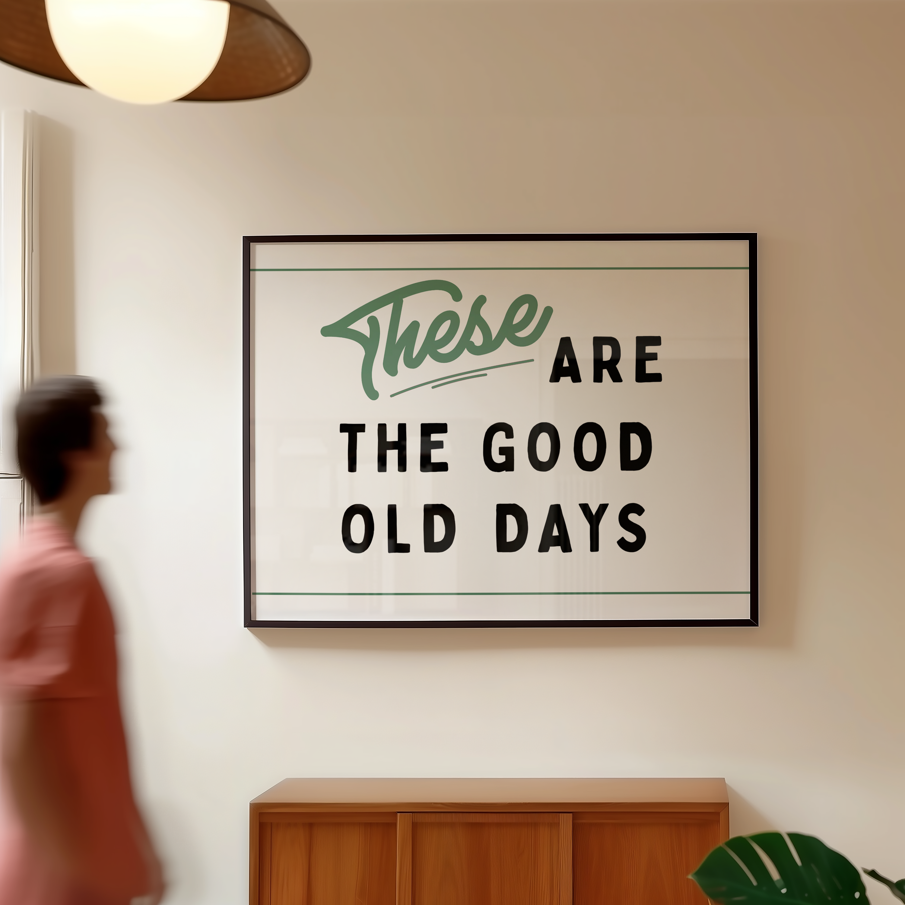 a framed sign with the text "These are the good old days" hanging on a wall.