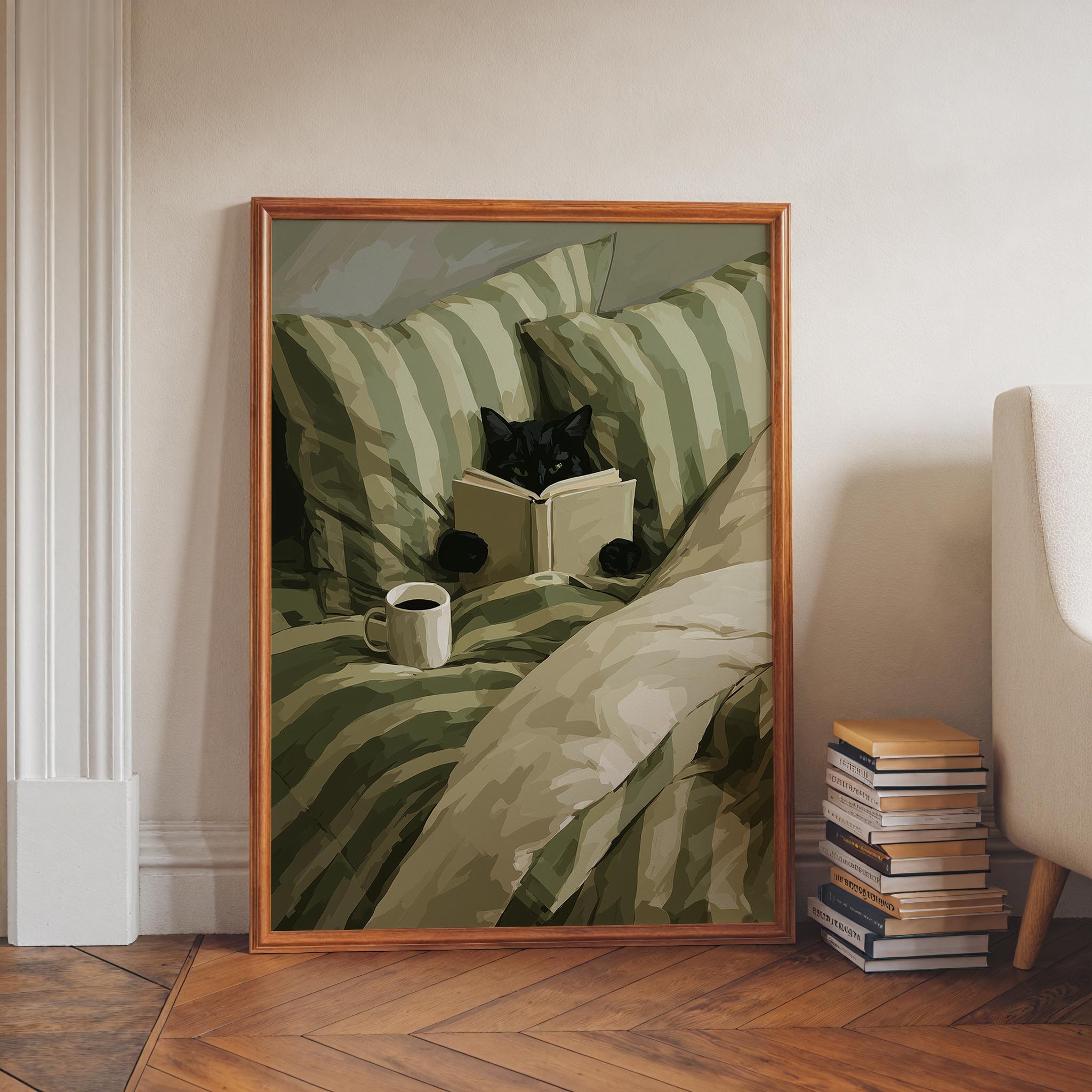 A framed painting depicting a black cat sitting on a bed and reading a book, with a cup of coffee nearby.