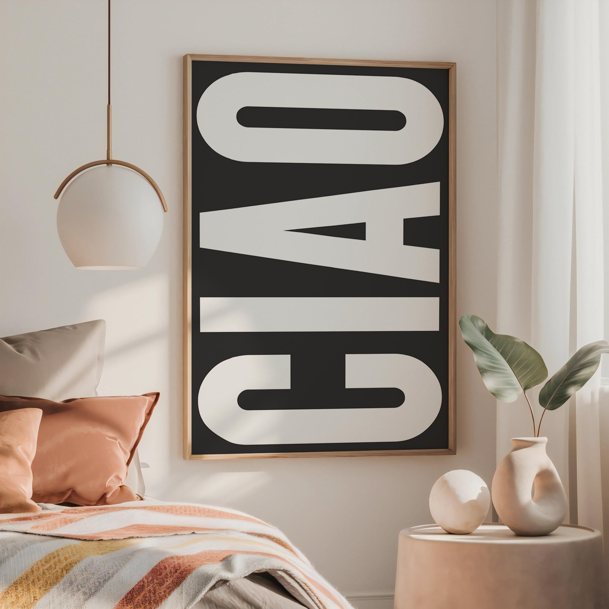 a bedroom with a large black and white framed text that says "Ciao" hanging on the wall. The room has a bed with a striped blanket, a pendant light, and a small side table with a vase and a plant.