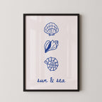 The image is a framed print with three blue illustrations of seashells and a text that reads "sun & sea".
