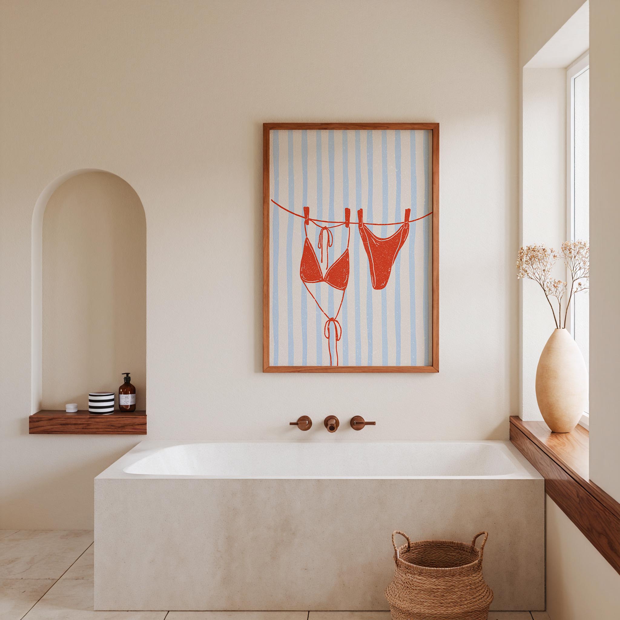 a bathroom with a white bathtub, a framed artwork of a red bikini on a clothesline, and a window with a vase of flowers.