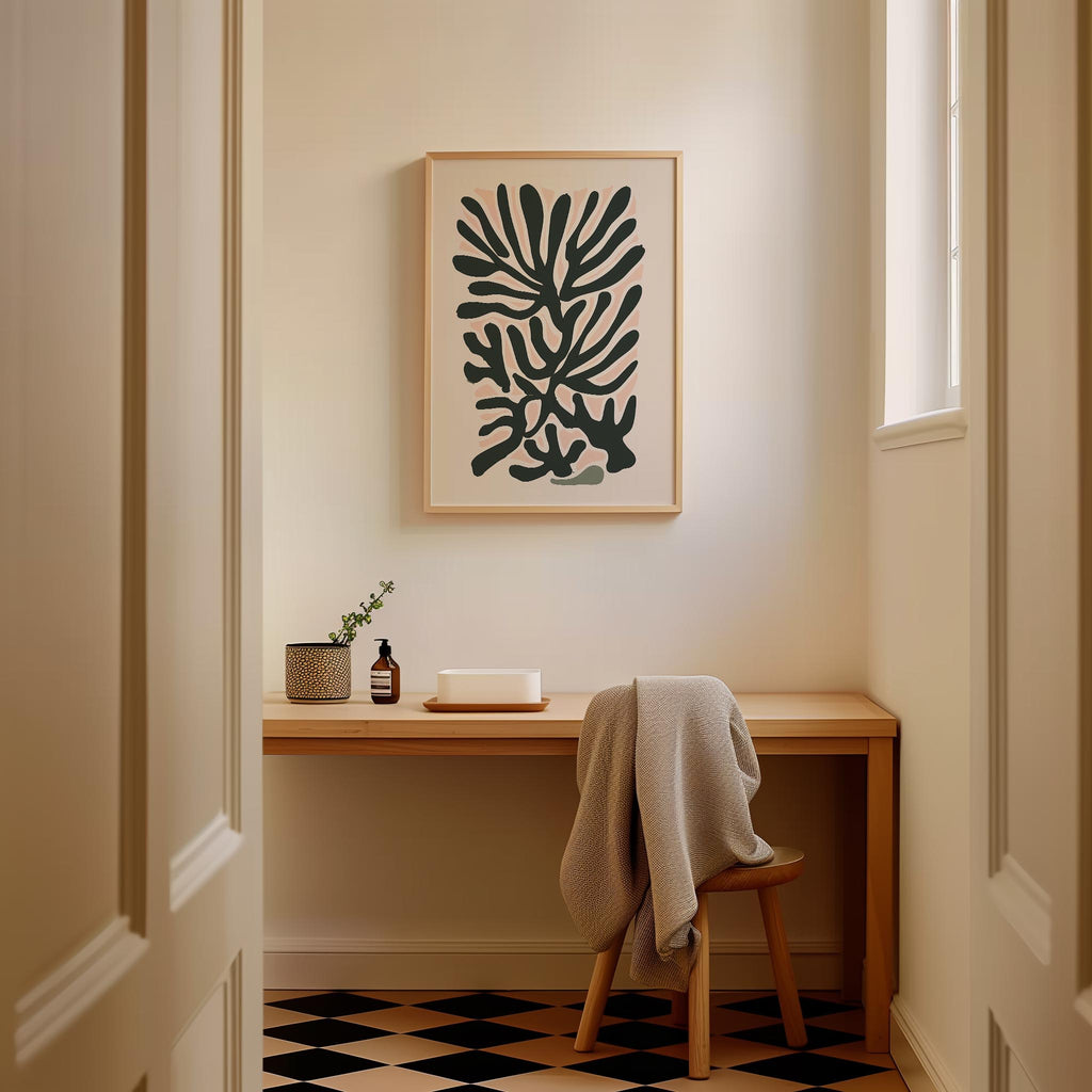 a cozy corner of a room with a wooden desk, a chair, and a framed abstract art piece hanging on the wall.