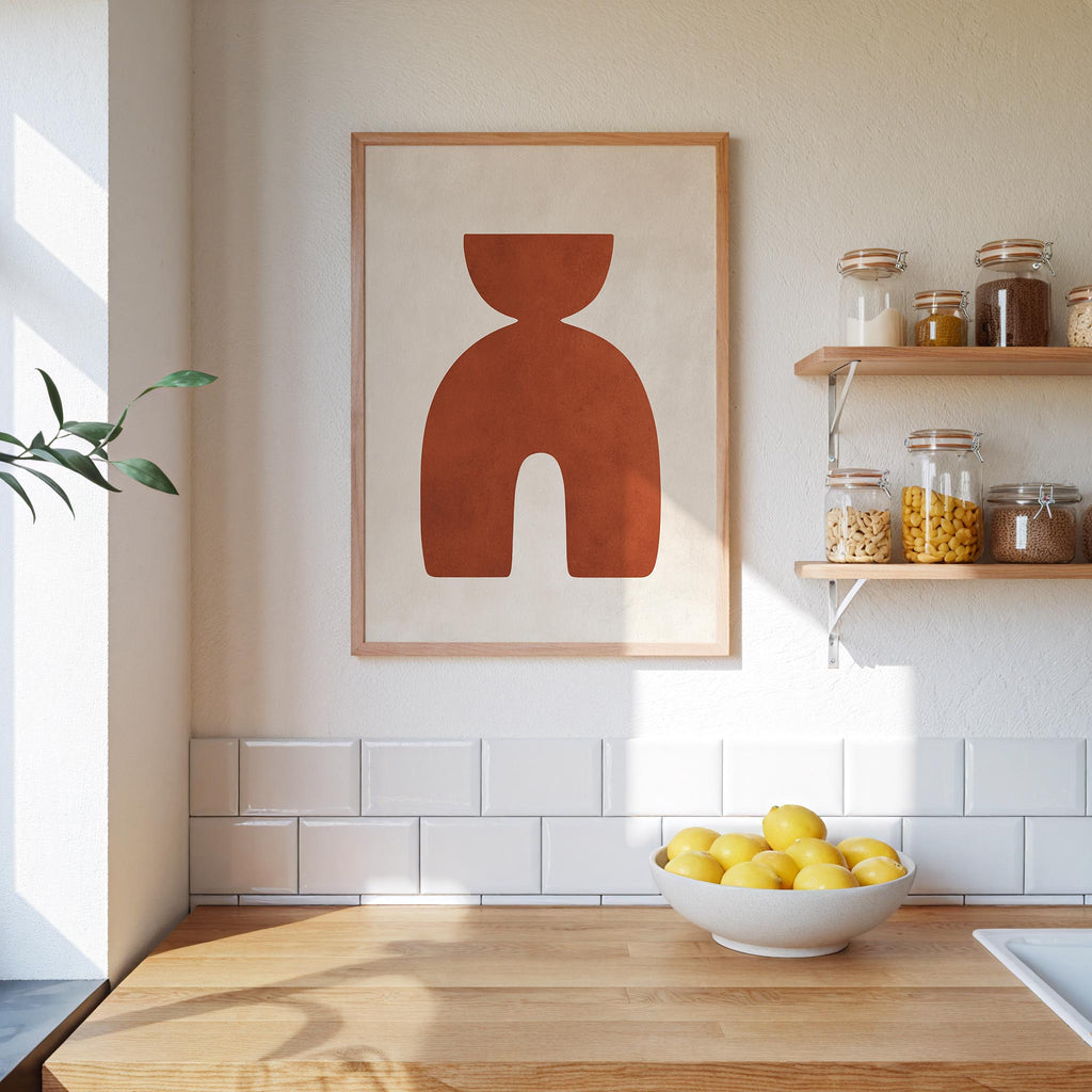 a kitchen counter with a bowl of lemons, a framed abstract art piece, and shelves displaying various jars and containers.