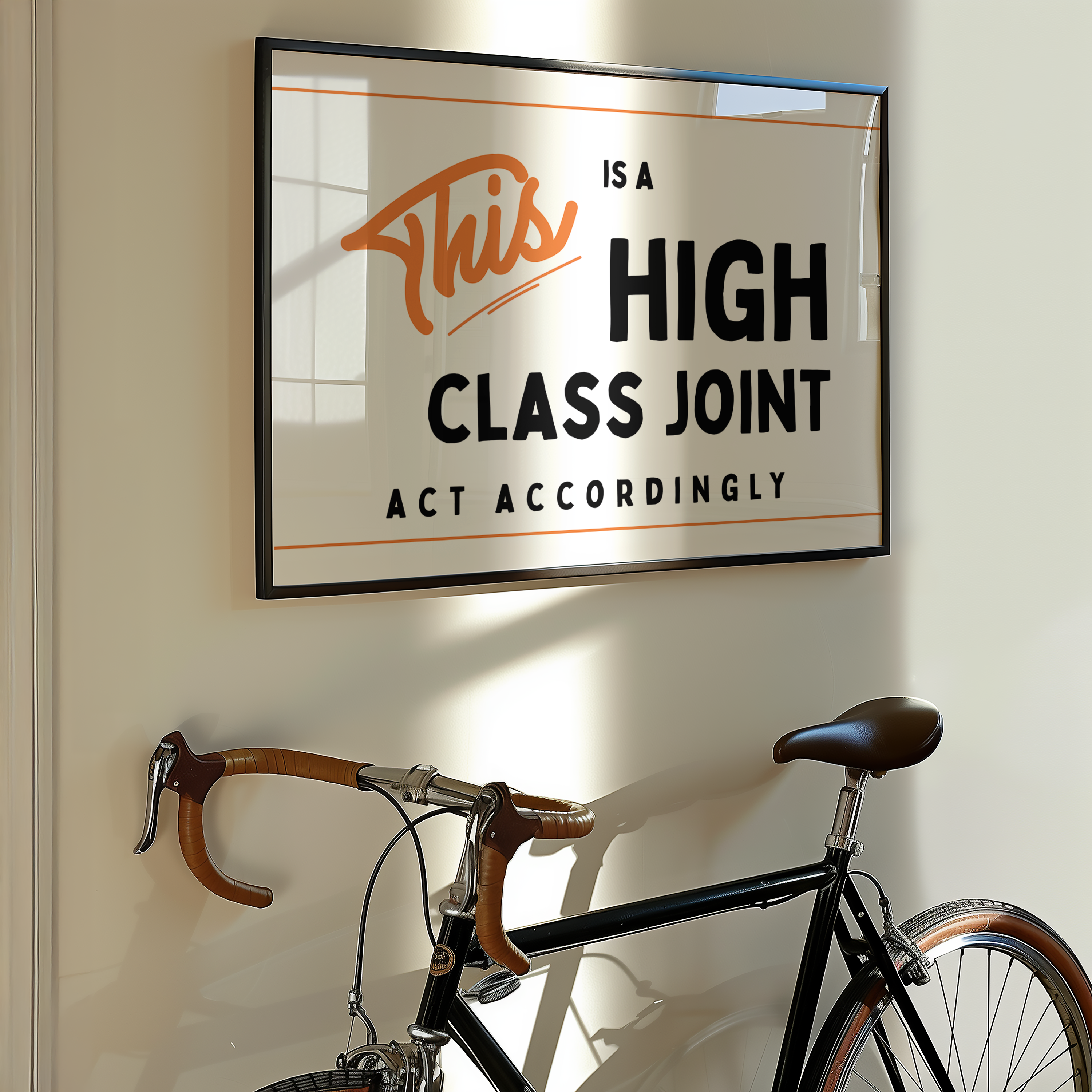 a framed sign with the text "This is a HIGH CLASS JOINT ACT ACCORDINGLY" hanging on a wall above a bicycle.