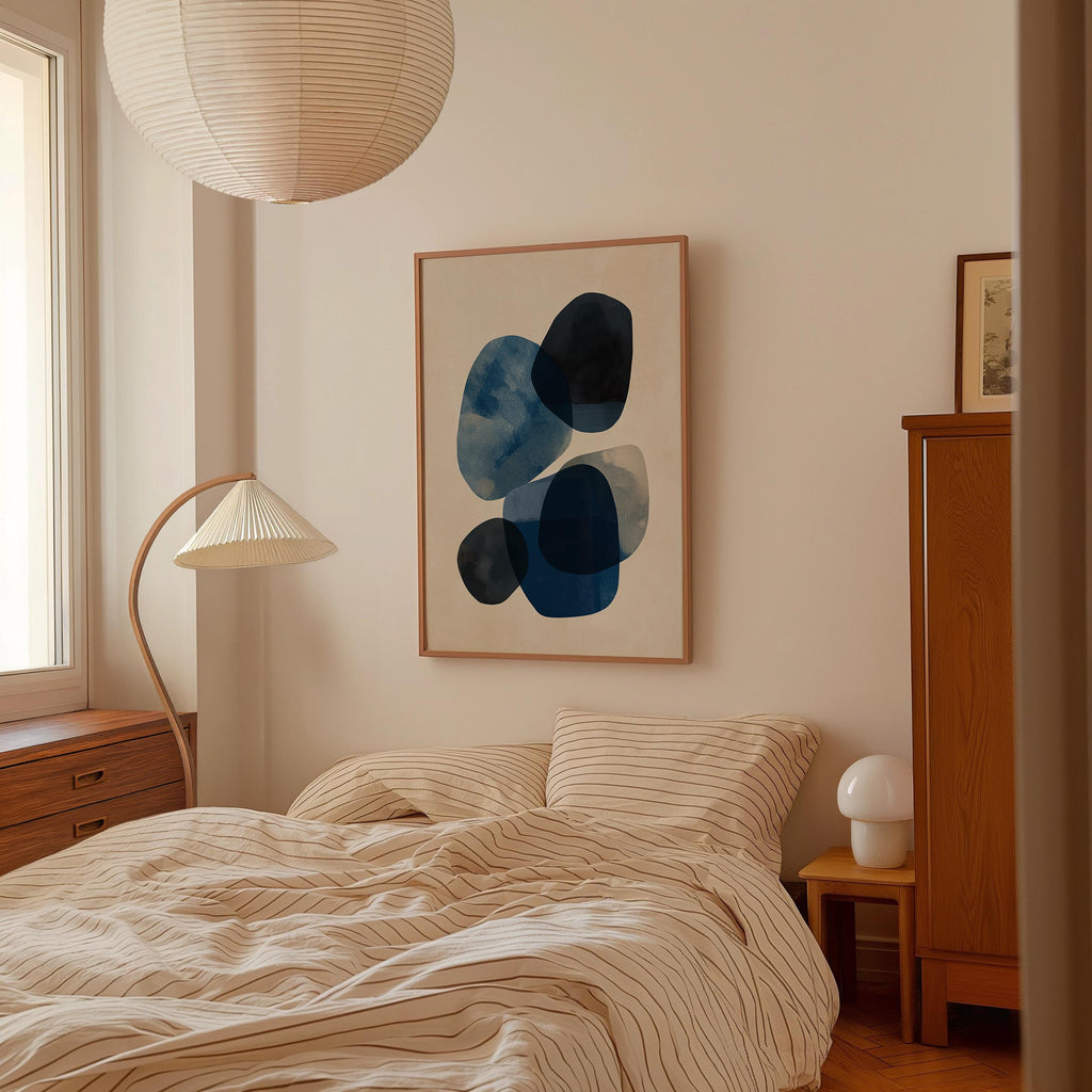 a cozy bedroom with a large bed, a wooden dresser, and a framed abstract artwork on the wall.
