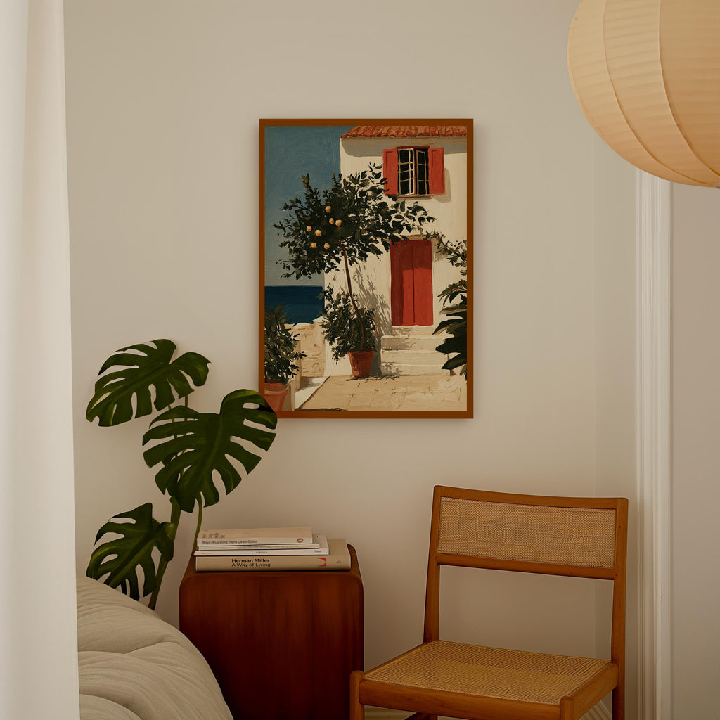 a cozy corner of a room with a painting of a house, a potted plant, and a wooden chair.