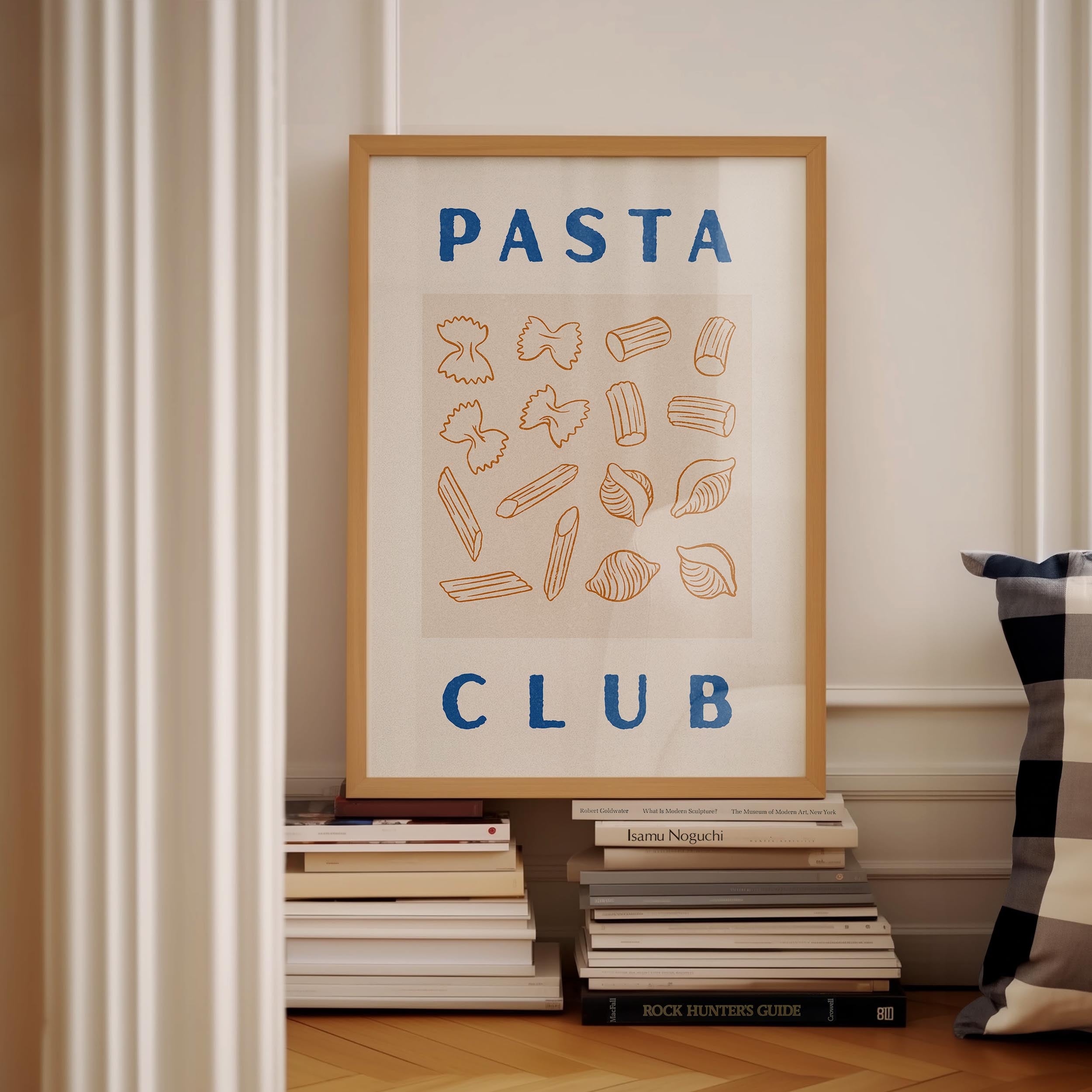 a framed poster with the text "PASTA CLUB" displayed prominently, surrounded by various pasta shapes and illustrations.