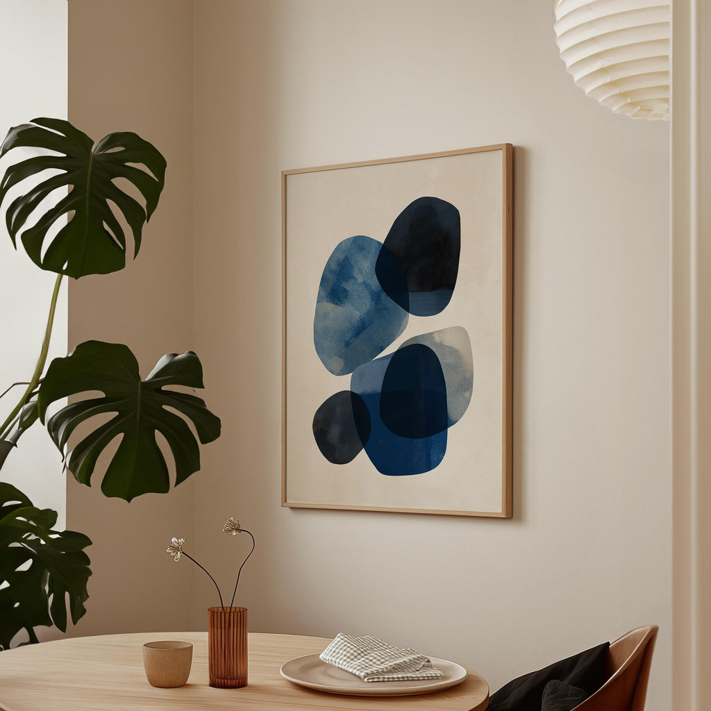 a minimalist dining area with a wooden table, a vase with flowers, and a framed abstract art piece hanging on the wall.