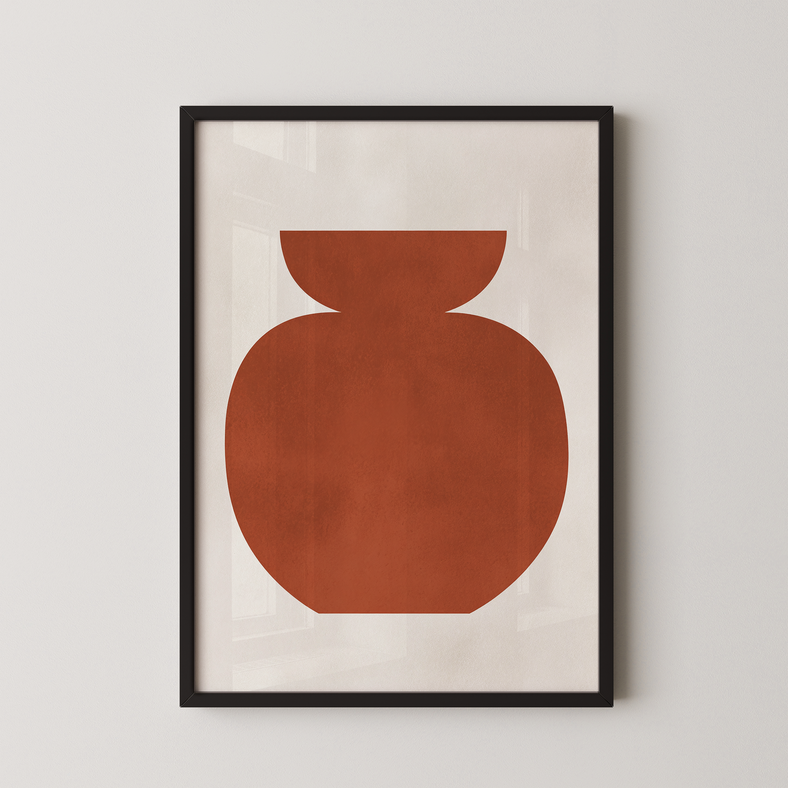 a simple, abstract design of a large orange shape, which appears to be a vase or container, displayed in a black frame on a white wall.