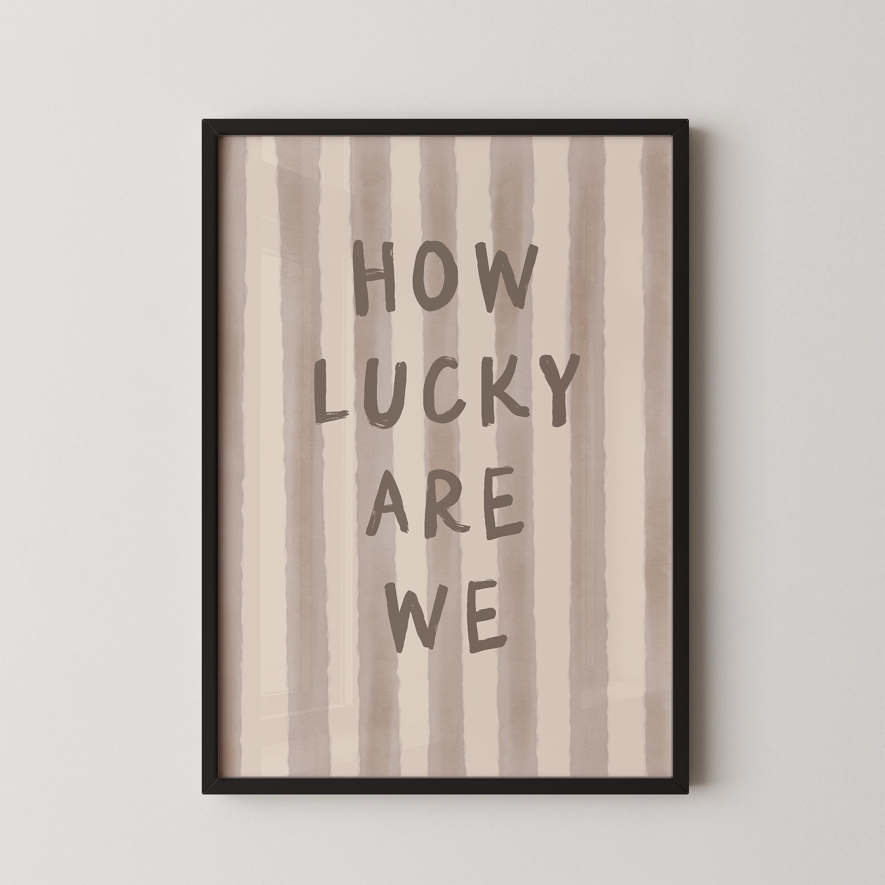 a framed print with the text "HOW LUCKY ARE WE" written on it.