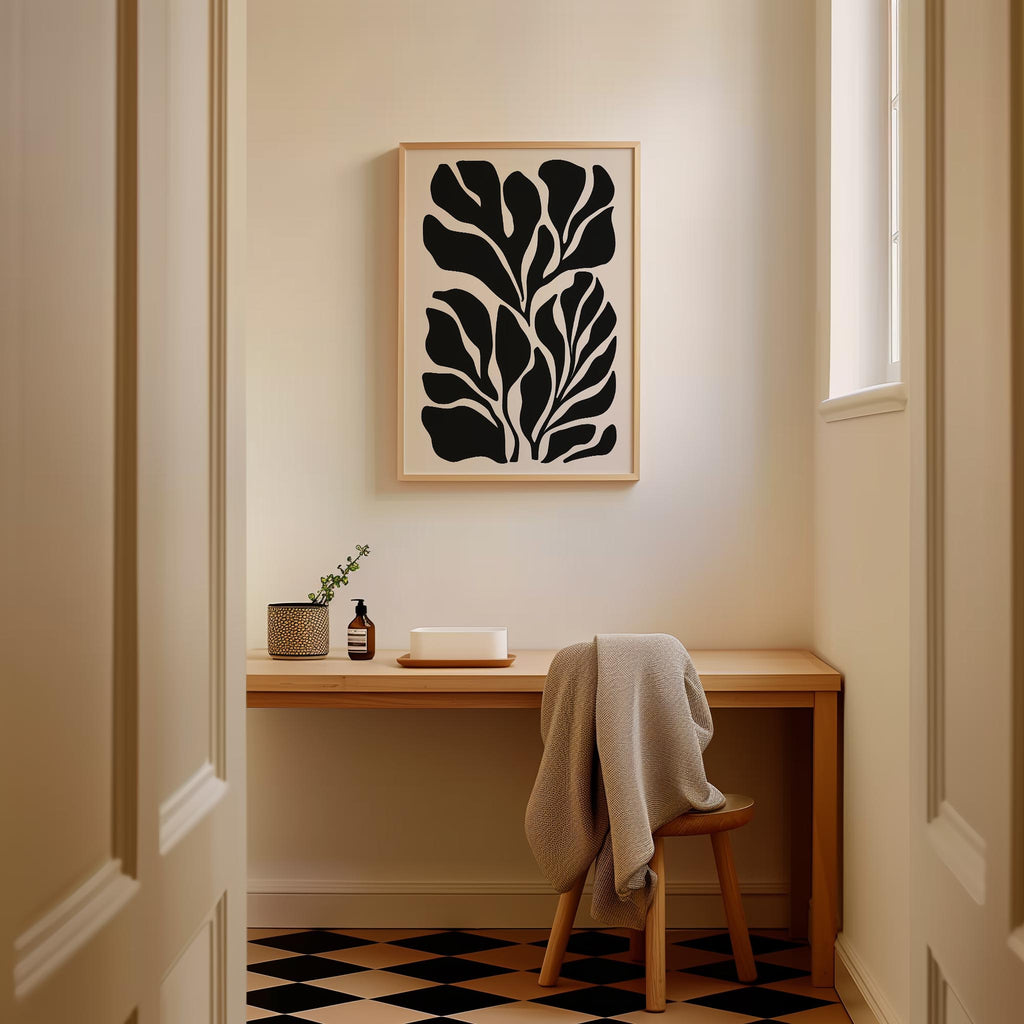 a cozy corner of a room with a wooden desk, a chair, and a framed abstract artwork hanging on the wall.