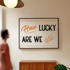 a person walking past a framed sign that reads "How Lucky Are We".