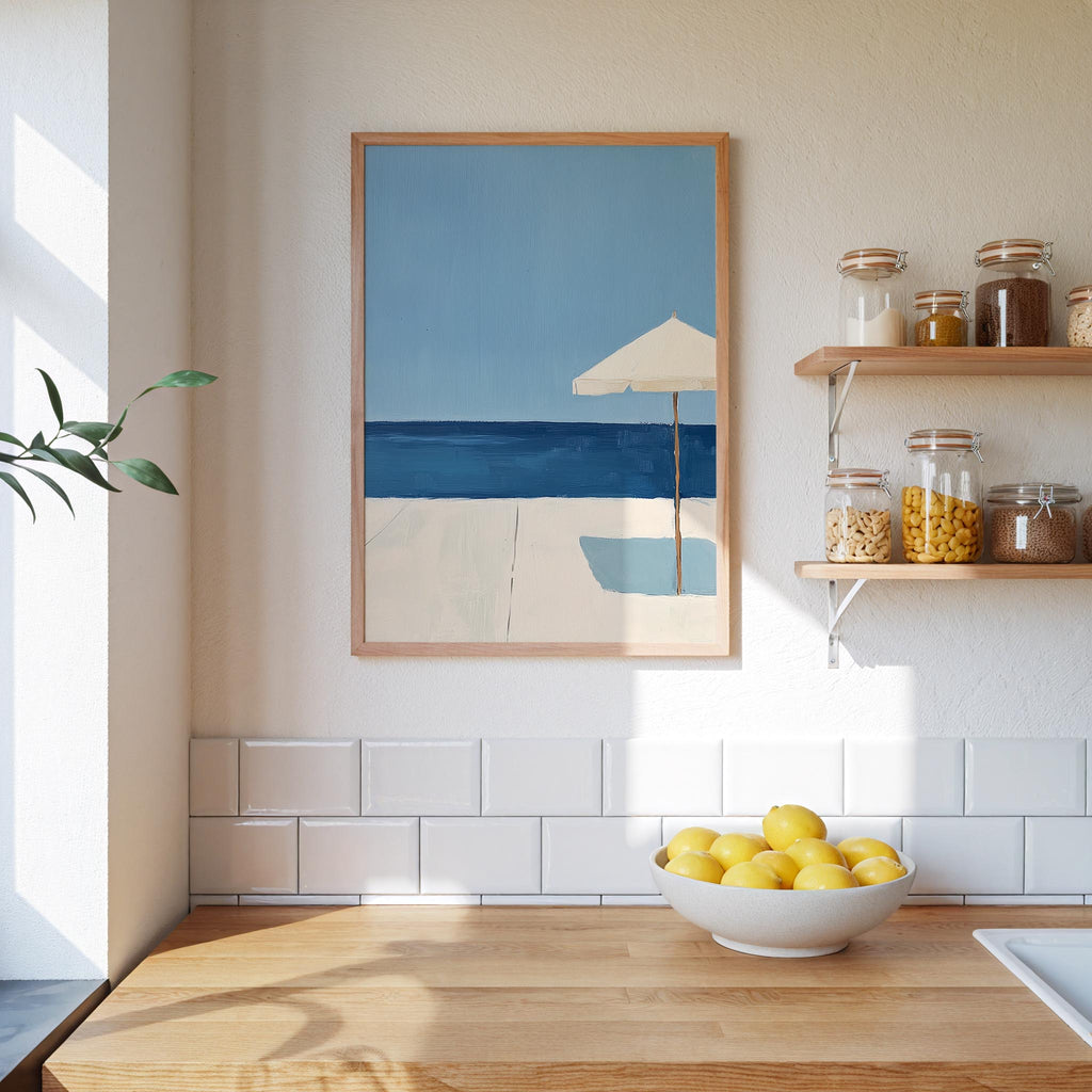 a kitchen counter with a bowl of lemons, a framed painting of a beach scene, and a shelf with jars and containers.