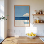 a kitchen counter with a bowl of lemons, a framed painting of a beach scene, and a shelf with jars and containers.