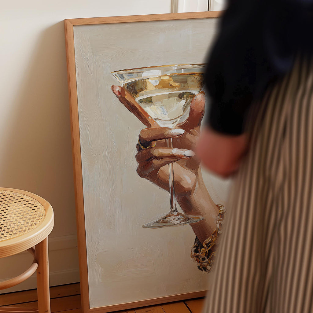 a person holding a glass of wine, with a painting of a hand holding a wine glass in the background.