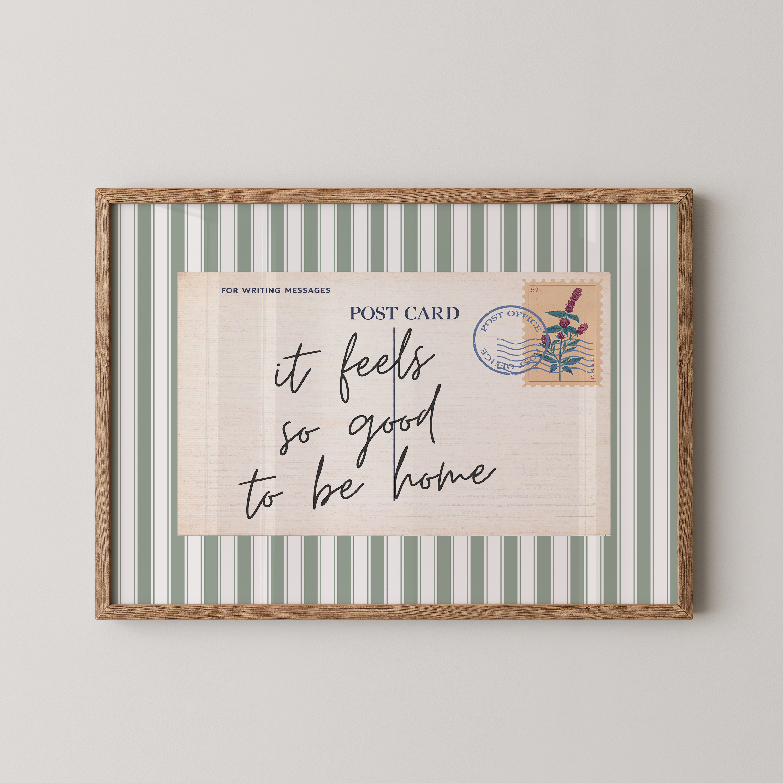 a framed postcard with a handwritten message that reads "it feels so good to be home".