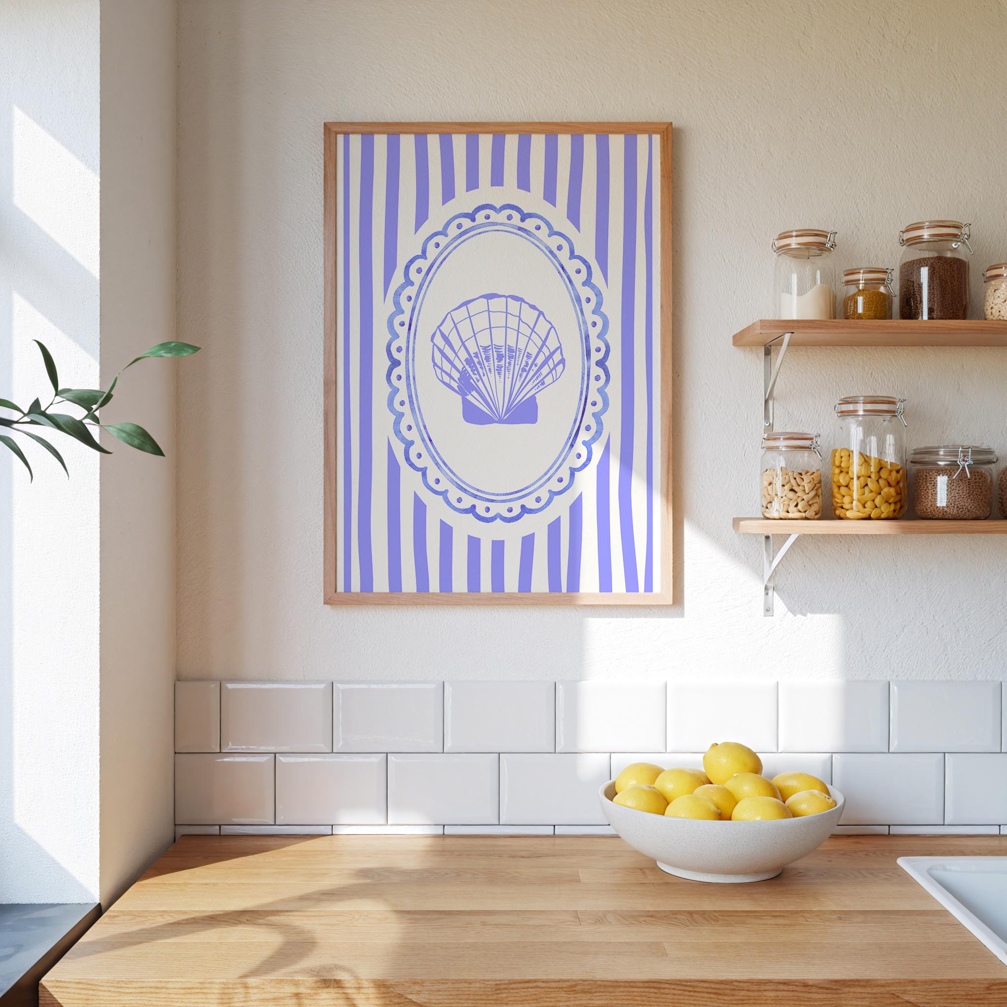 a kitchen counter with a bowl of lemons, a framed picture of a shell, and various jars and containers on a shelf.