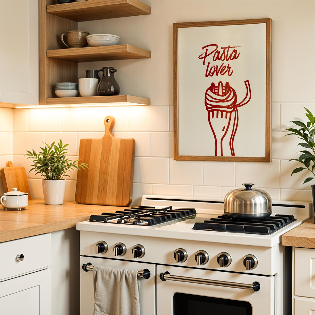 A kitchen scene with a framed poster of a fork and noodles, a stove with a pot on it, and various kitchen items such as a cutting board, a plant, and a cup.
