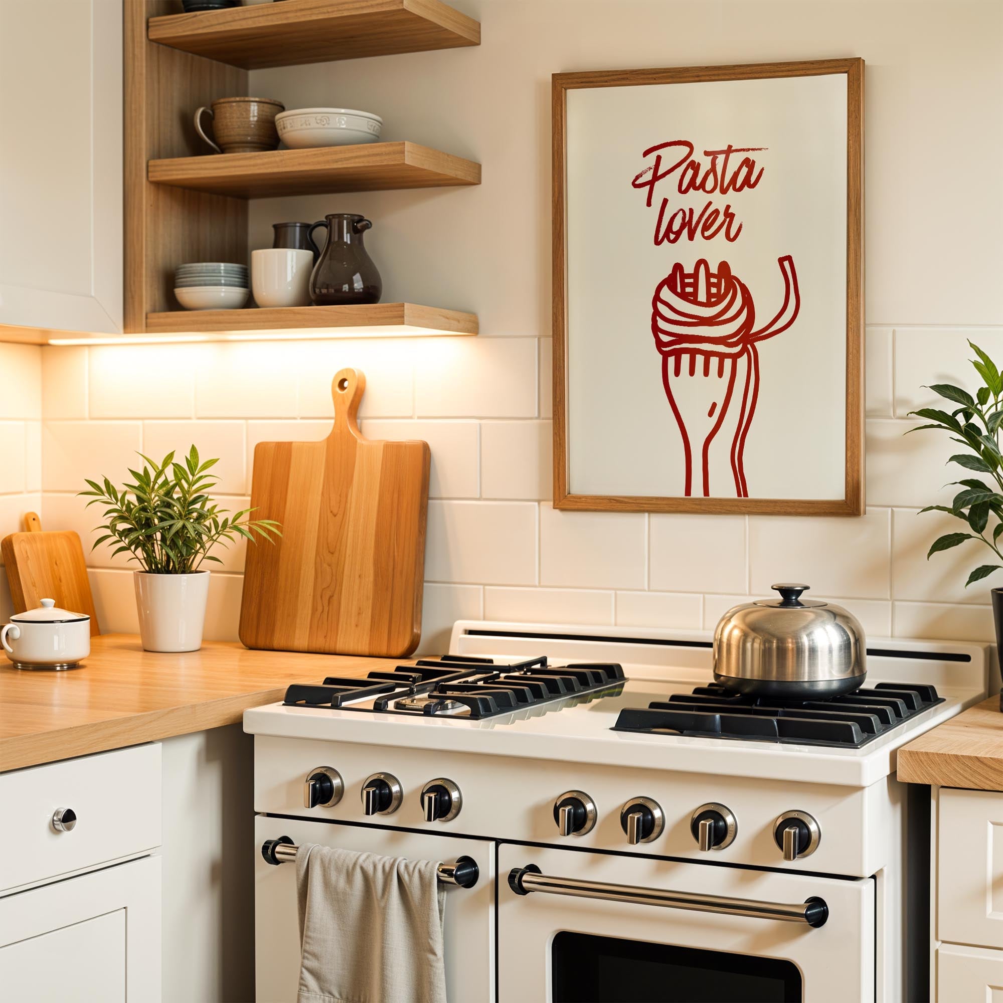 A kitchen scene with a framed poster of a fork and noodles, a stove with a pot on it, and various kitchen items such as a cutting board, a plant, and a cup.