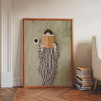 A framed painting of a person in a striped outfit holding a book, standing in front of a green wall.