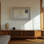 a minimalist living room with a wooden cabinet, a bed, and a framed poster on the wall.