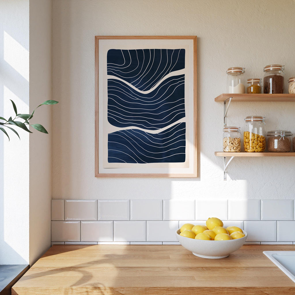 a kitchen counter with a bowl of lemons, a framed abstract art piece, and shelves displaying various jars and containers.