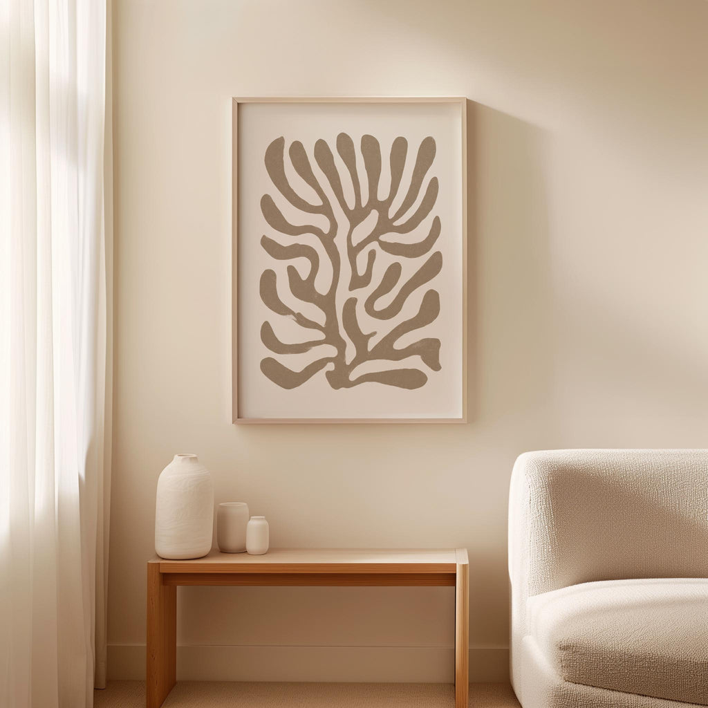 a minimalist living room with a white sofa, a wooden side table, and a framed abstract art piece hanging on the wall above the side table.