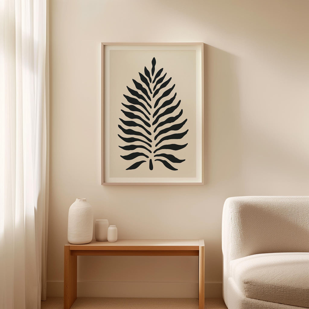 a minimalist living room with a large black and white abstract leaf artwork hanging on the wall above a wooden side table.