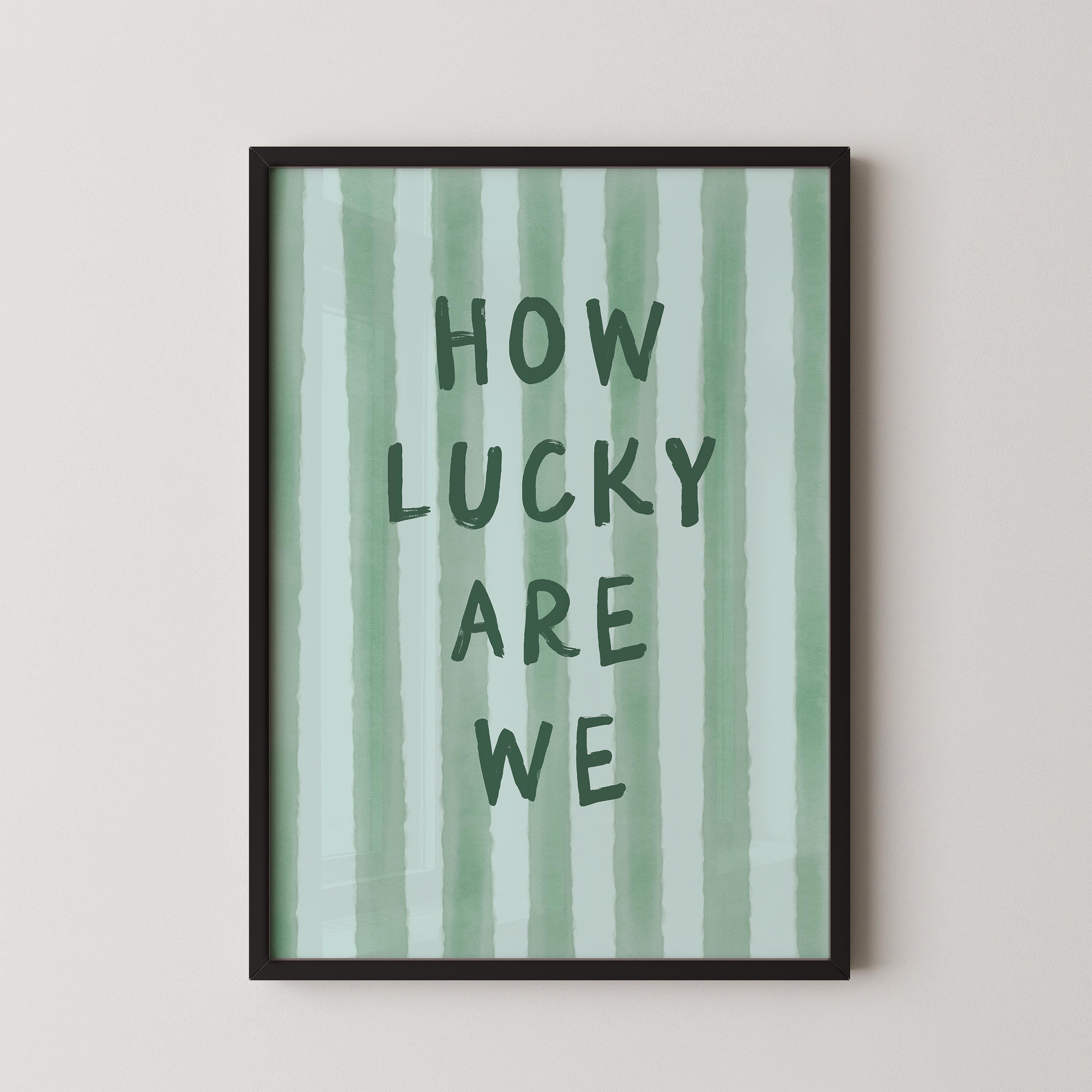 a framed poster with the text "HOW LUCKY ARE WE" written on it.