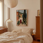 a cozy bedroom with a large bed, a wooden dresser, and a painting of a picturesque town hanging on the wall.